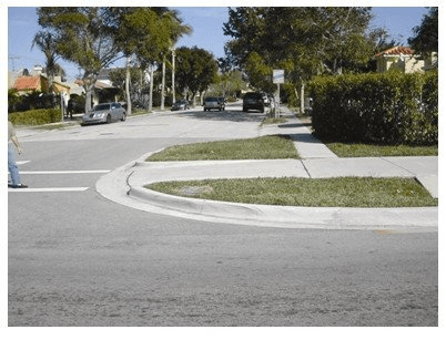 A sidewalk that meets the street in one direction but requires pedestrians to backtrack to continue with a left or right turn